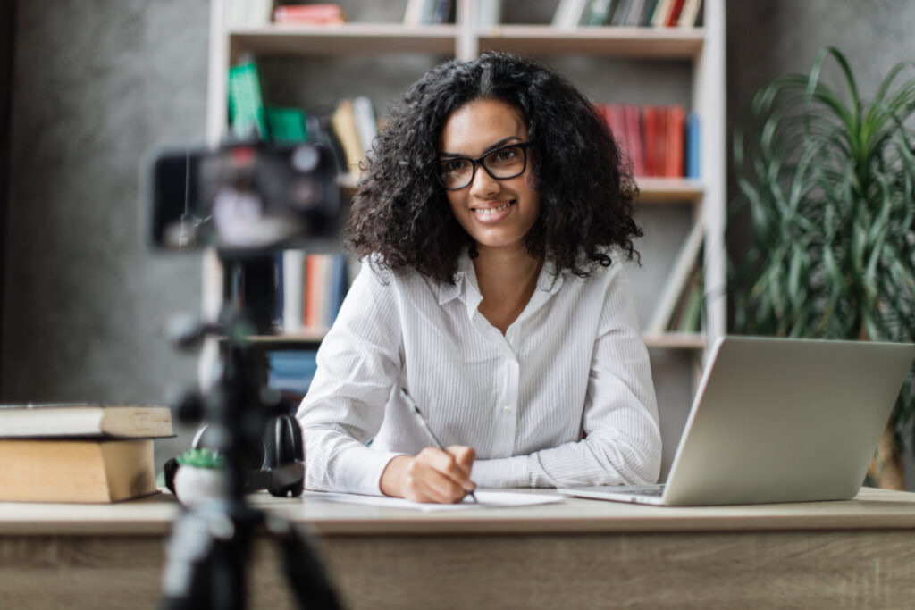 A person creating engaging content on a laptop, surrounded by creative elements like graphics, charts, and social media icons.